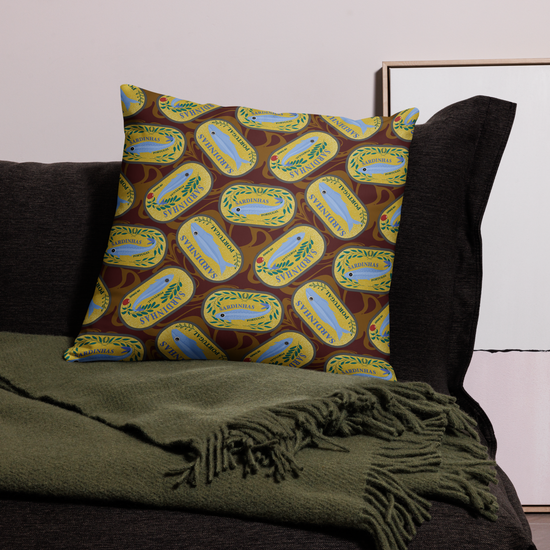 Pillow with sardine can design on a couch with green blanket. sardines (yellow can) all-over-print pillows
