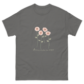 Gray t-shirt featuring a design of four pink flowers with green stems and leaves, and the text flowers make me happy. Flowers make me happy Poppy Blooms tee