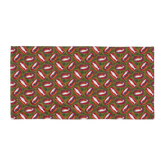 Patterned fabric featuring repeated fish illustrations on a green and red background. Sardines (Red Can) Beach Towel