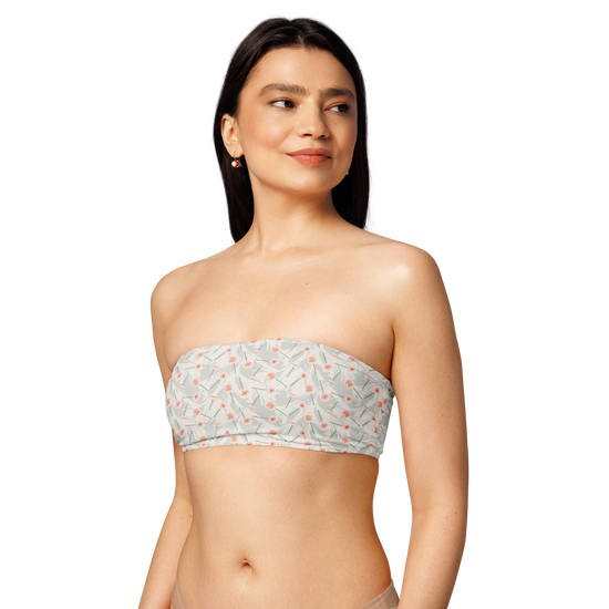 Woman wearing a floral-patterned strapless bandeau top.