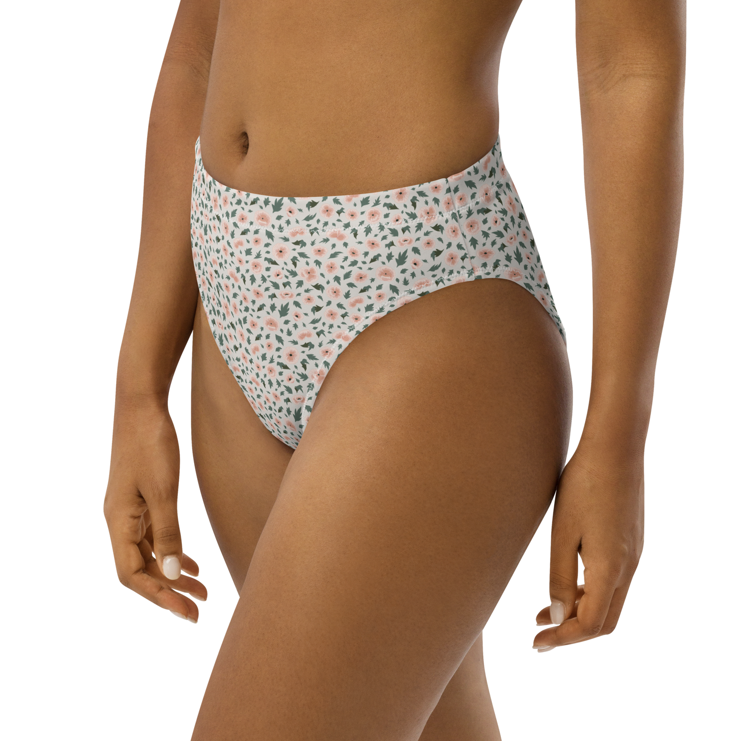 Woman wearing high-waisted bikini bottom with floral pattern in pink and green on white background.