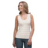 Woman wearing a white tank top with thin orange stripes and gray leggings.