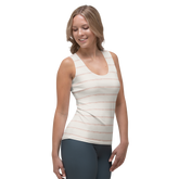 Woman wearing a white tank top with thin orange stripes and gray leggings.