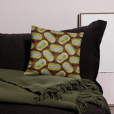 Decorative pillow with sardine can design on a dark couch. sardines (yellow can) all-over-print pillows